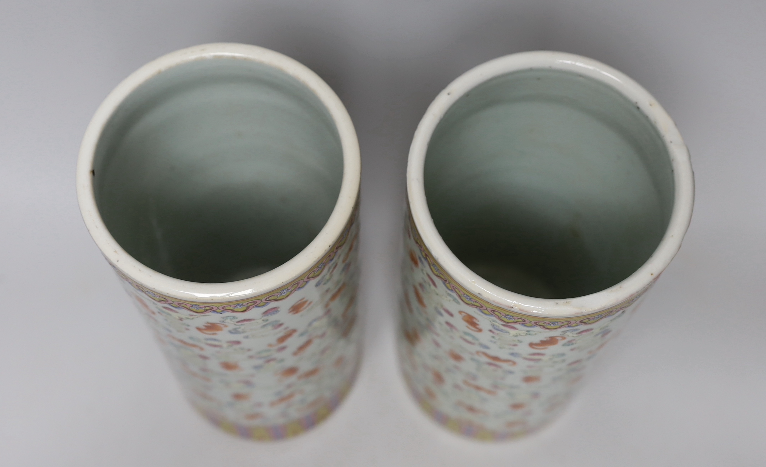 A pair of Chinese famille rose cylindrical vases, decorated with bats, each 29cm high